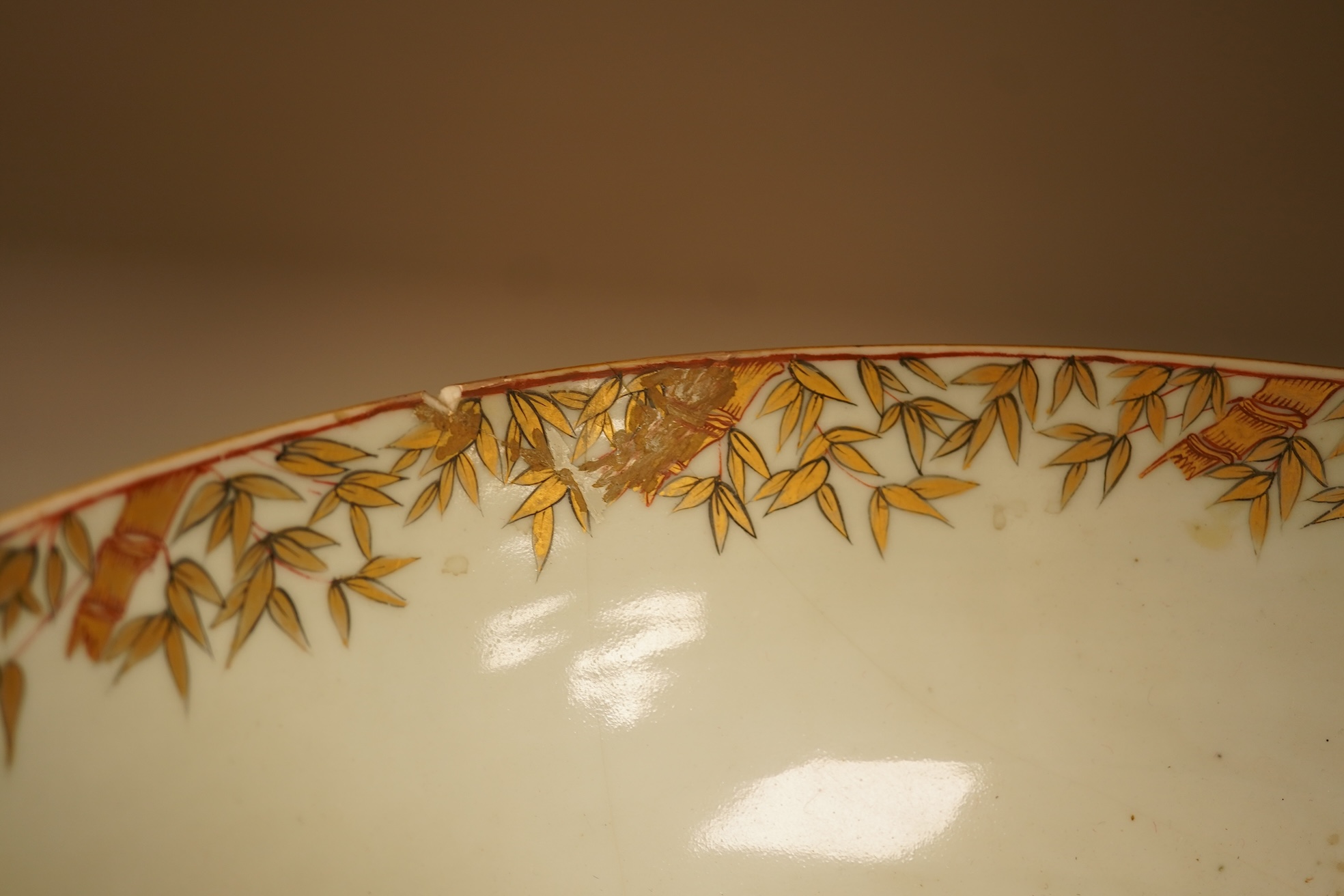 An 18th century Chinese famille rose figural bowl, on wooden stand, 34cm diameter.